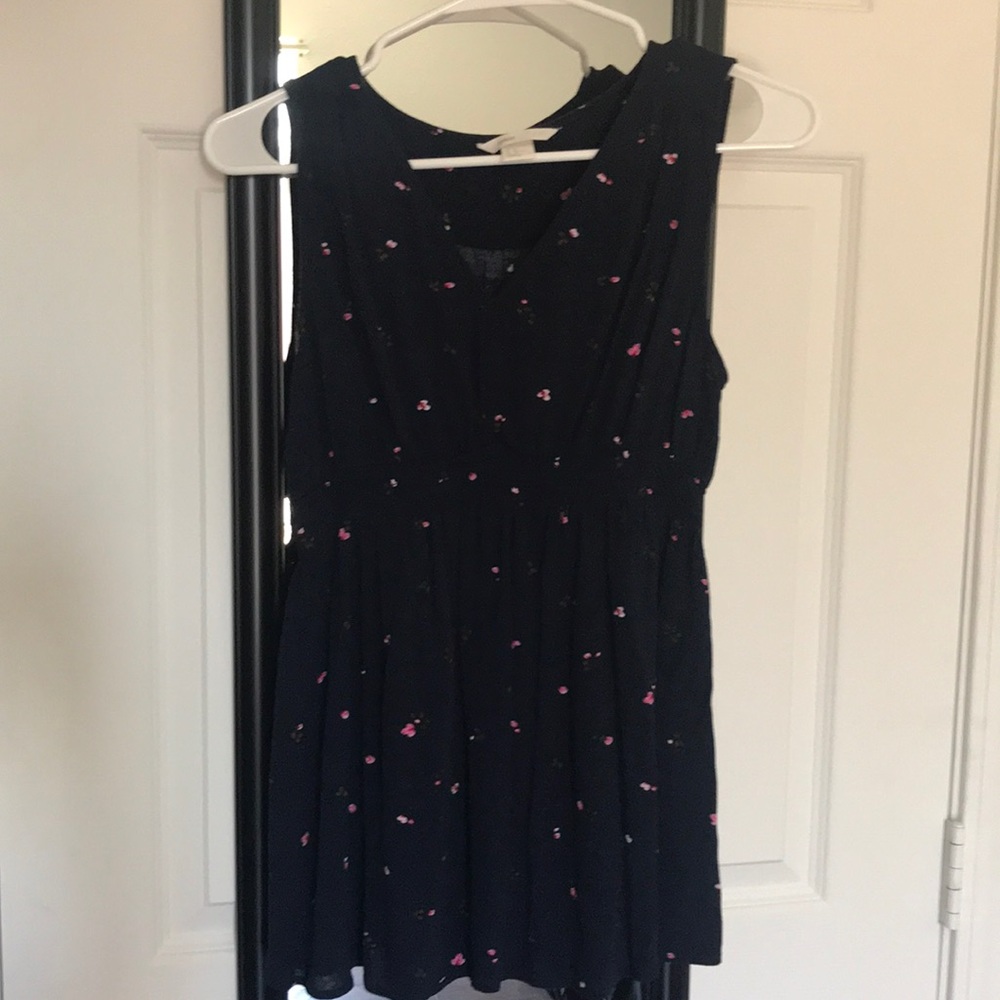 A cute blouse has pink flowers on it dark blue